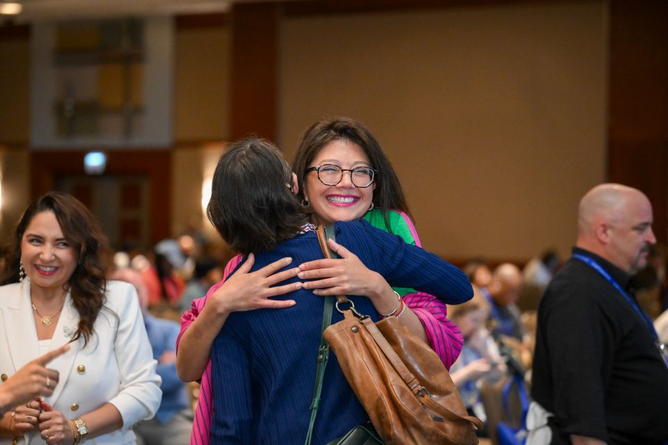 conference attendees hugging